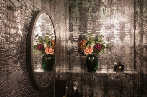 Dunkles Badezimmer mit schimmernden Strukturwänden